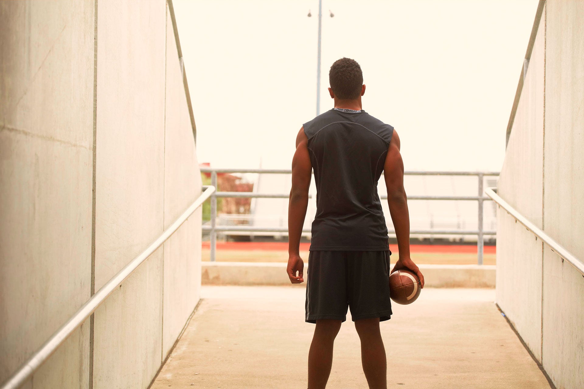 goat-directive-male-athlete-holding-football
